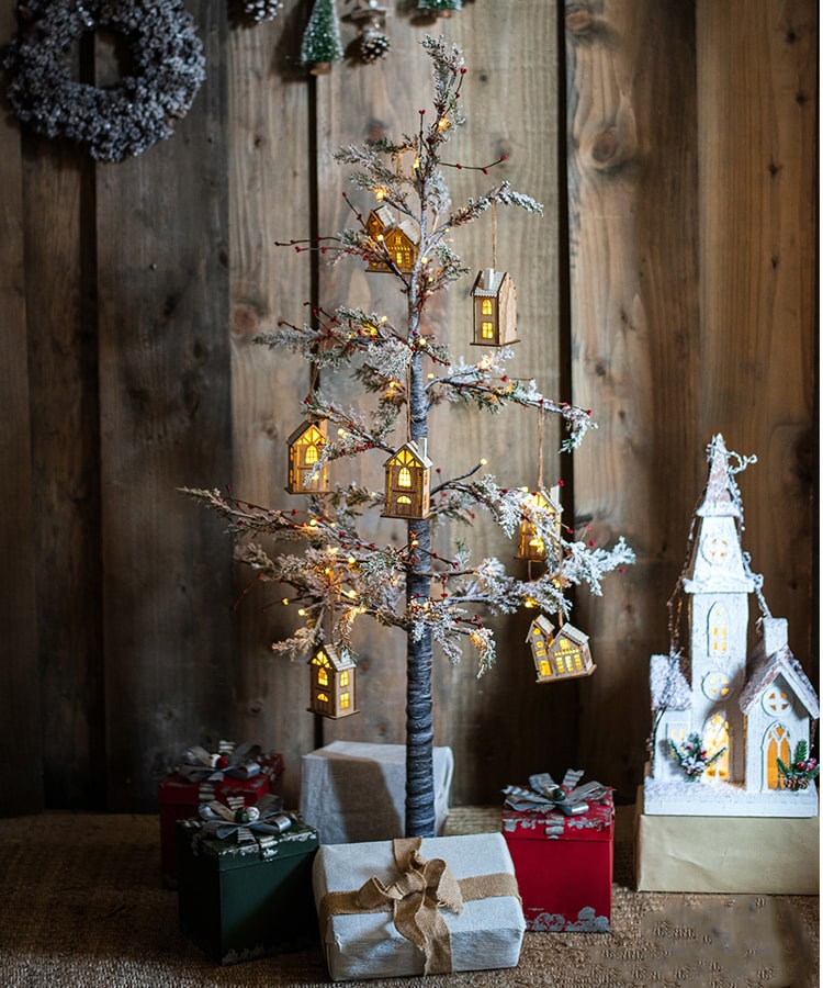 A beautifully decorated Snow Flocked Lighted Christmas Tree with red berry branches, standing 49.6 inches tall, showcasing a wintery aesthetic.