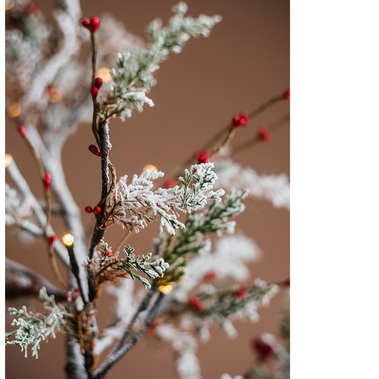 A beautifully decorated Snow Flocked Lighted Christmas Tree with red berry branches, standing 49.6 inches tall, showcasing a wintery aesthetic.