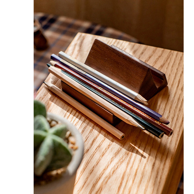 A handcrafted solid wood cellphone stand made from white ash, cherry, or walnut, showcasing its unique design and natural finish.