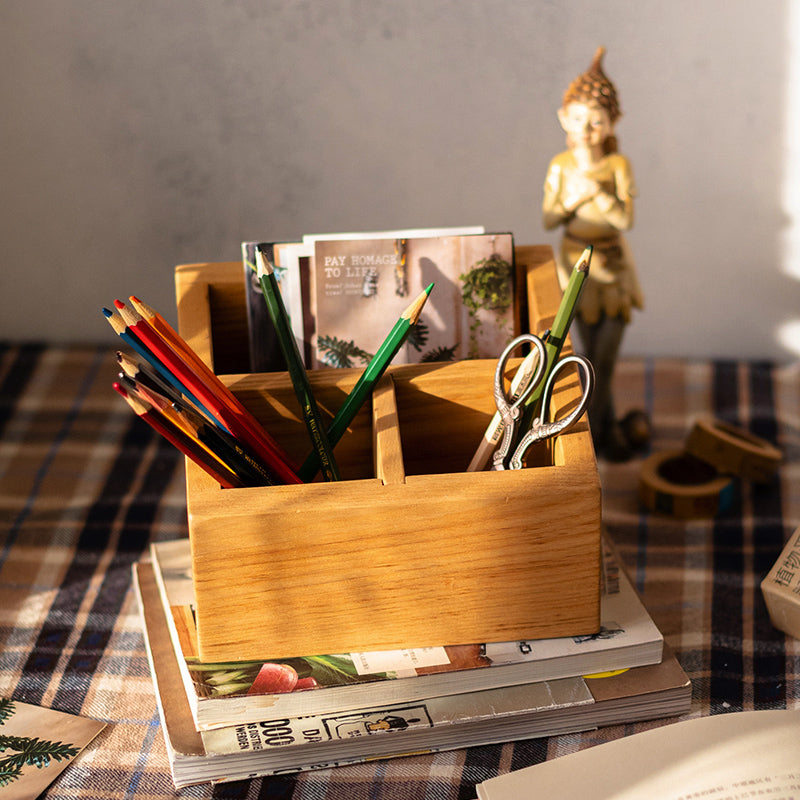 A handcrafted solid wood desktop organizer in natural brown, featuring compartments for pens and small office supplies.