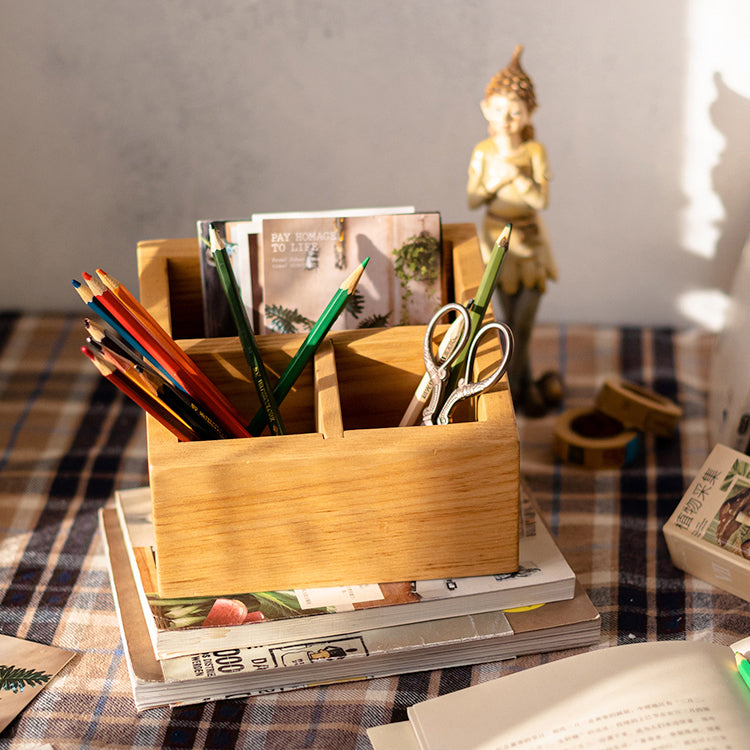 A handcrafted solid wood desktop organizer in natural brown, featuring compartments for pens and small office supplies.