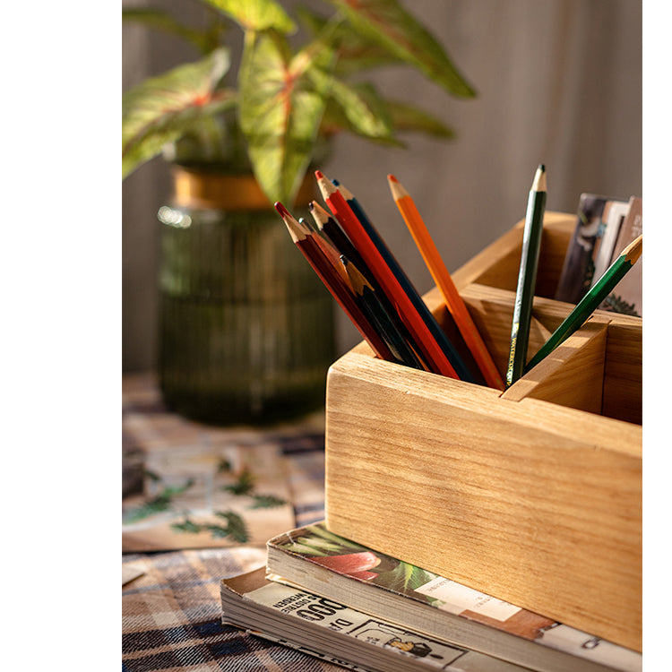 A handcrafted solid wood desktop organizer in natural brown, featuring compartments for pens and small office supplies.