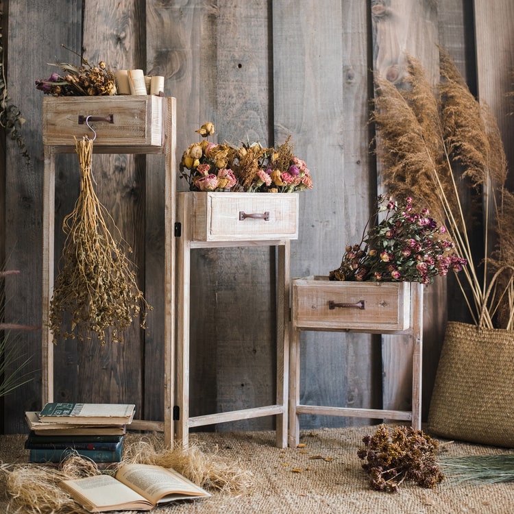 Solid wood decorative plant stand with drawer, showcasing a natural tan finish and sturdy design, perfect for indoor plants.