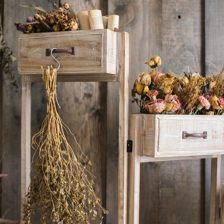 Solid wood decorative plant stand with drawer, showcasing a natural tan finish and sturdy design, perfect for indoor plants.