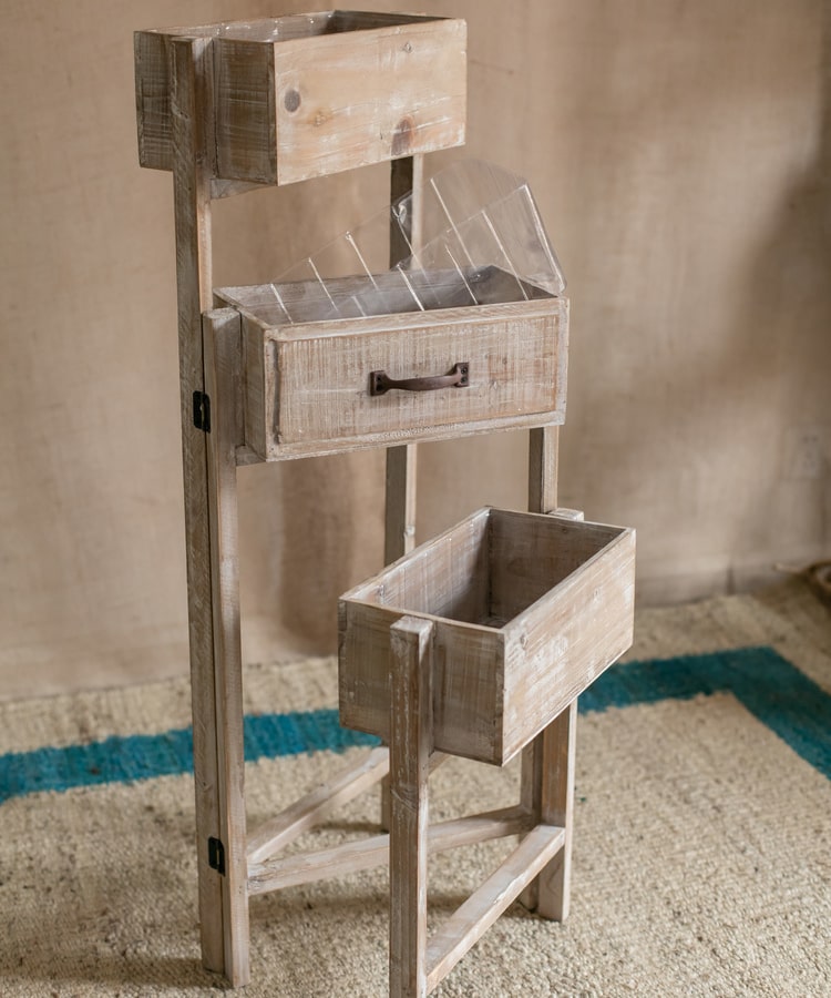 Solid wood decorative plant stand with drawer, showcasing a natural tan finish and sturdy design, perfect for indoor plants.