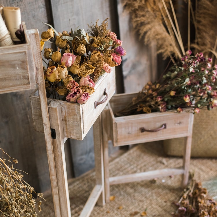 Solid wood decorative plant stand with drawer, showcasing a natural tan finish and sturdy design, perfect for indoor plants.