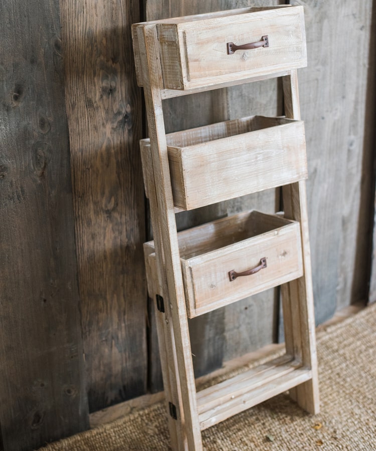 Solid wood decorative plant stand with drawer, showcasing a natural tan finish and sturdy design, perfect for indoor plants.