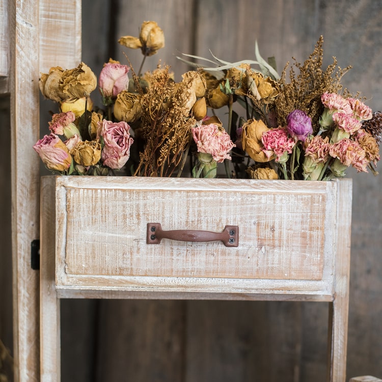 Solid wood decorative plant stand with drawer, showcasing a natural tan finish and sturdy design, perfect for indoor plants.