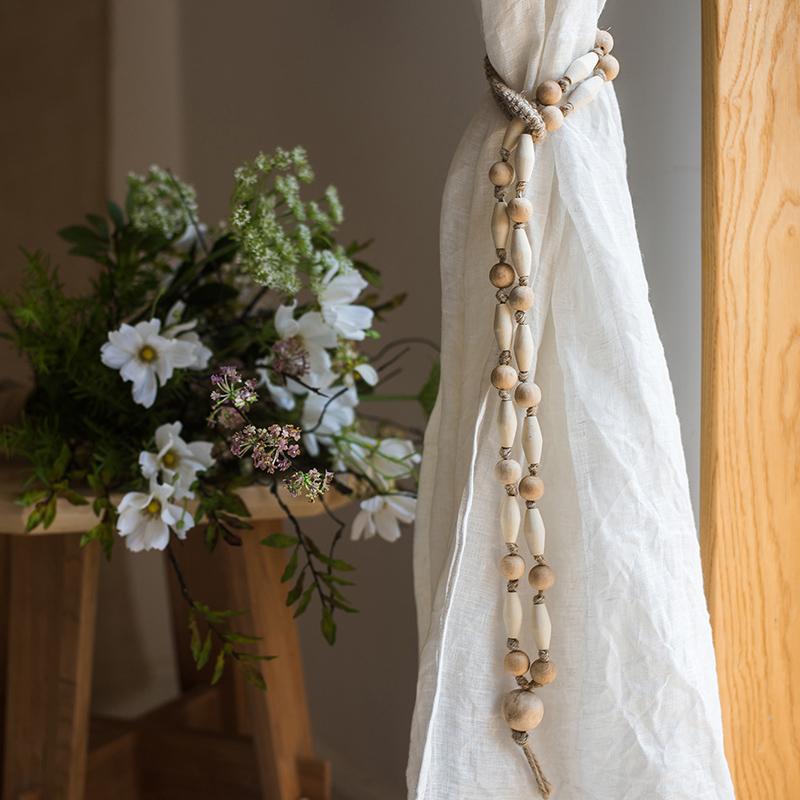 Solid wood handmade rustic curtain tiebacks in beige and khaki colors, showcasing their elegant design and craftsmanship.