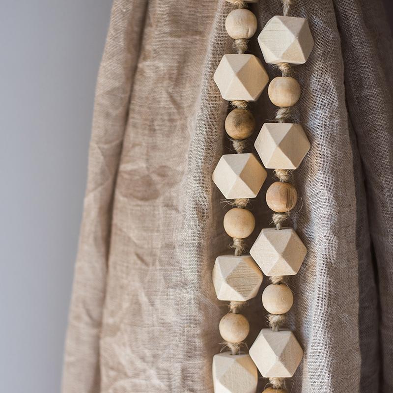 Solid wood handmade rustic curtain tiebacks in beige and khaki colors, showcasing their elegant design and craftsmanship.