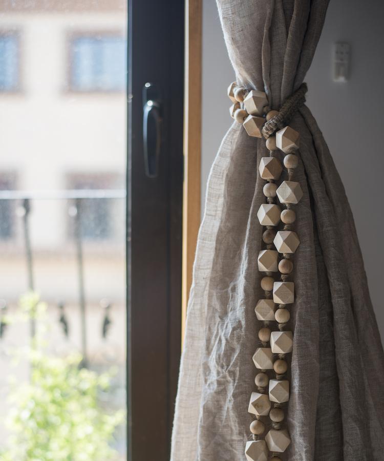 Solid wood handmade rustic curtain tiebacks in beige and khaki colors, showcasing their elegant design and craftsmanship.