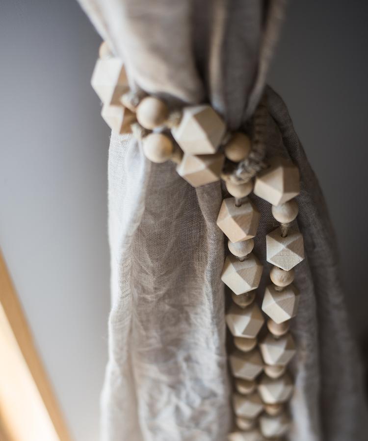 Solid wood handmade rustic curtain tiebacks in beige and khaki colors, showcasing their elegant design and craftsmanship.