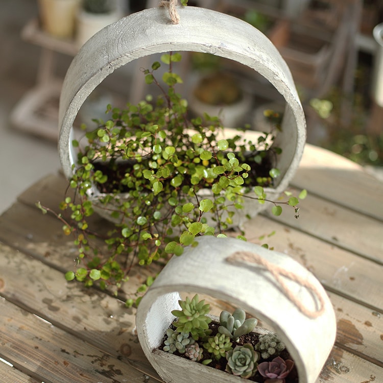 Solid Wood Hanging Planter in round shape, crafted from Paulownia wood, available in white and light gray colors.