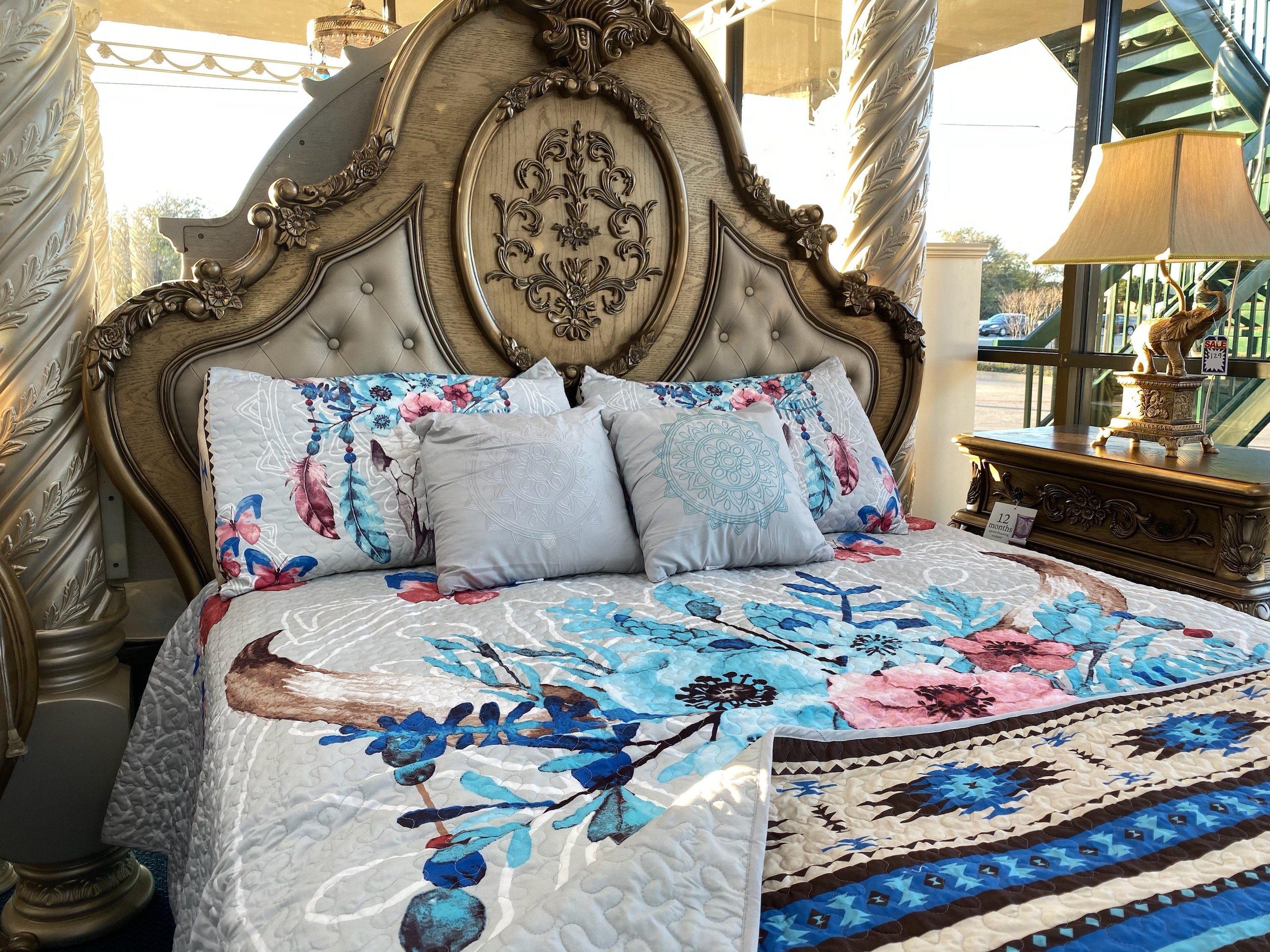 Southwest Feathers & Flowers Bull Skull Aztec Quilt Coverlet set featuring a bull skull design with colorful feathers and flowers, includes quilt and pillows.