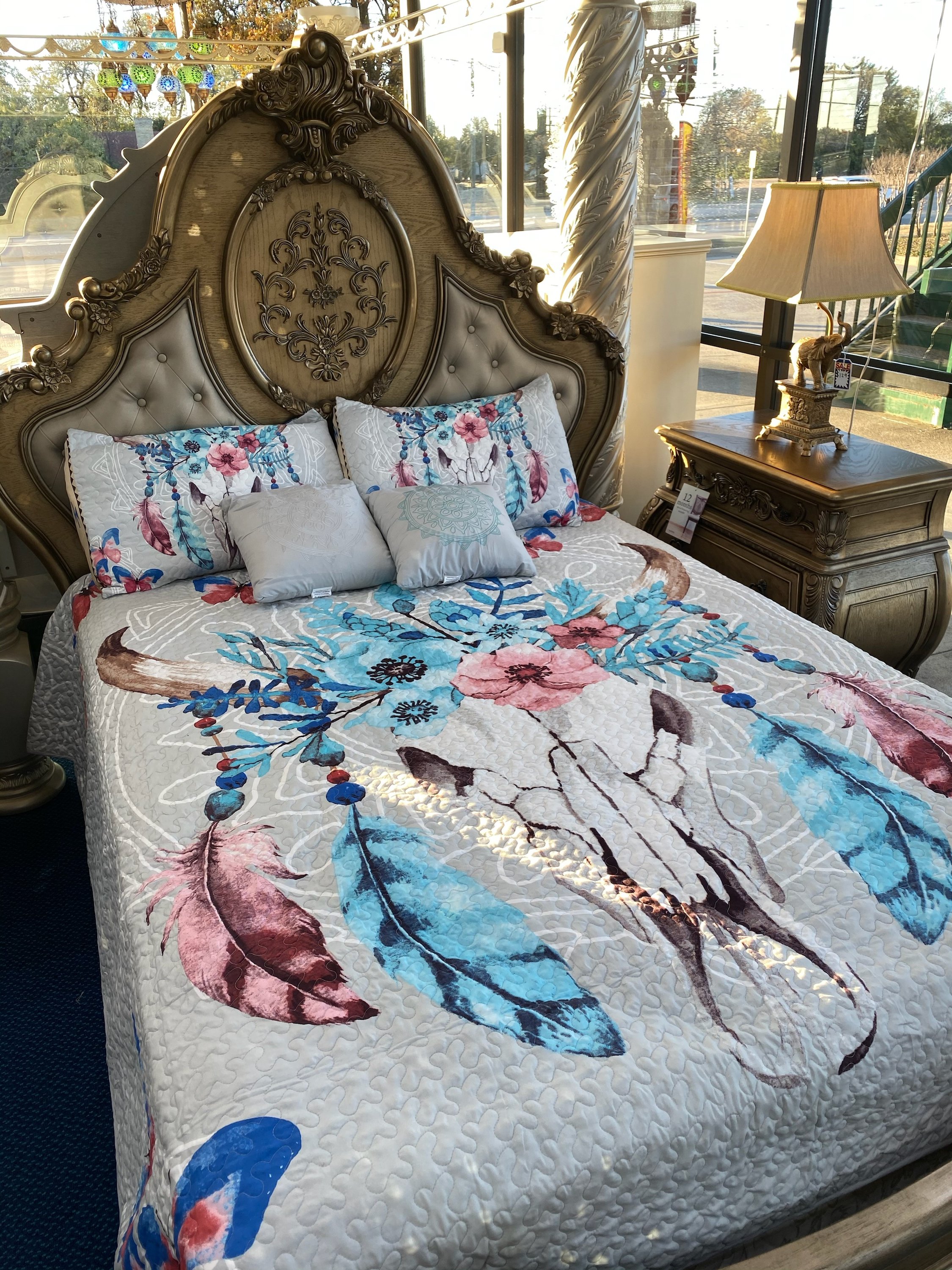 Southwest Feathers & Flowers Bull Skull Aztec Quilt Coverlet set featuring a bull skull design with colorful feathers and flowers, includes quilt and pillows.