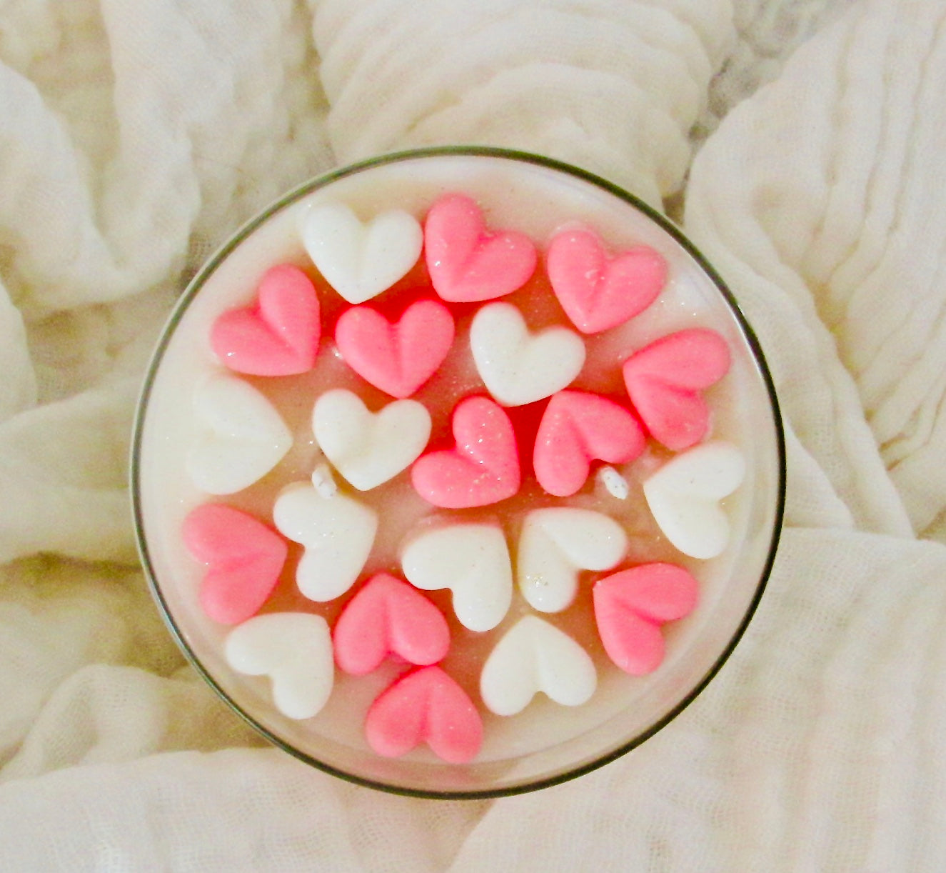 A beautifully crafted soy wax candle with heart shapes, featuring creamy vanilla notes and a warm glow, perfect for home decor or gifting.