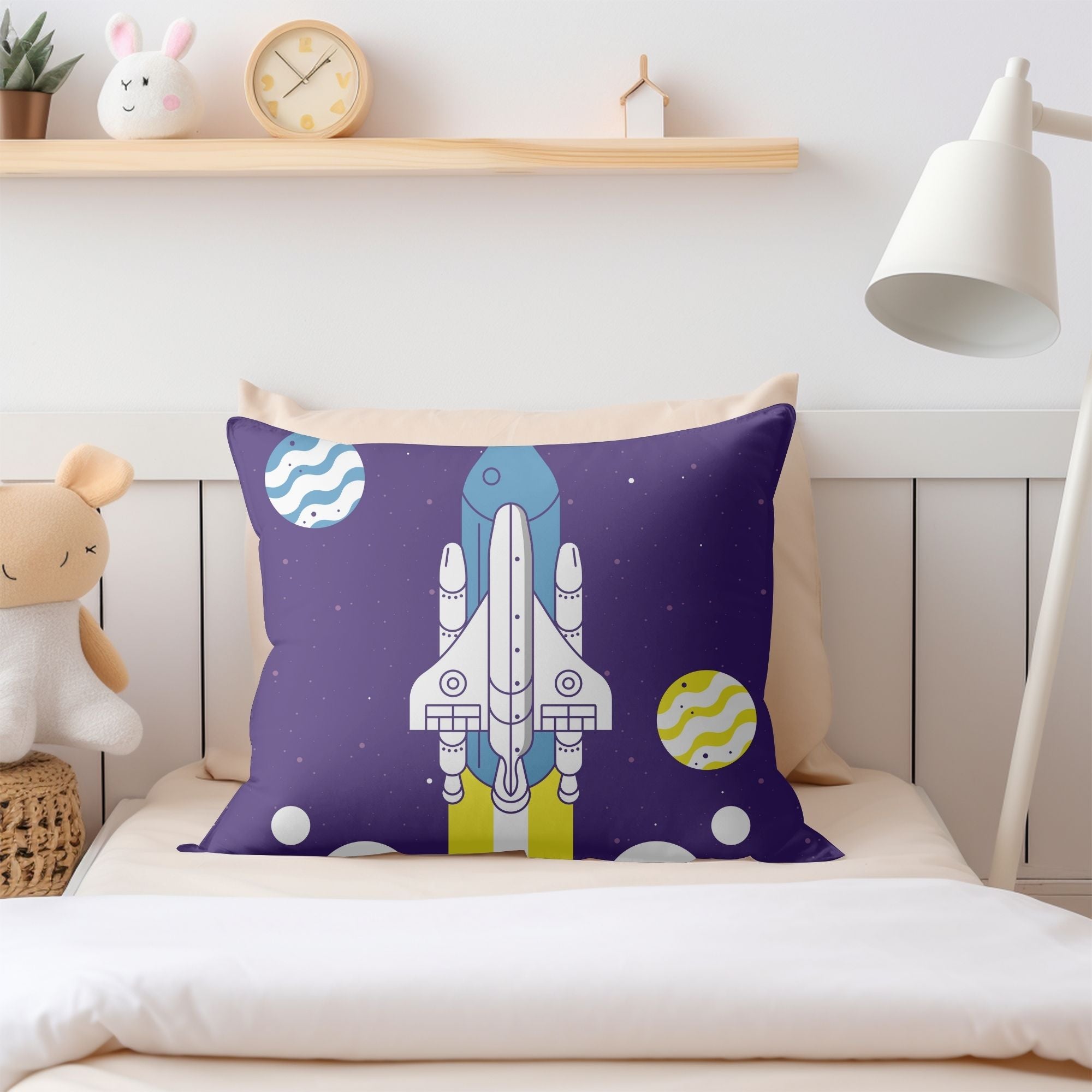 A colorful kids pillow featuring a vibrant space rocket design, perfect for children's rooms and outdoor use.