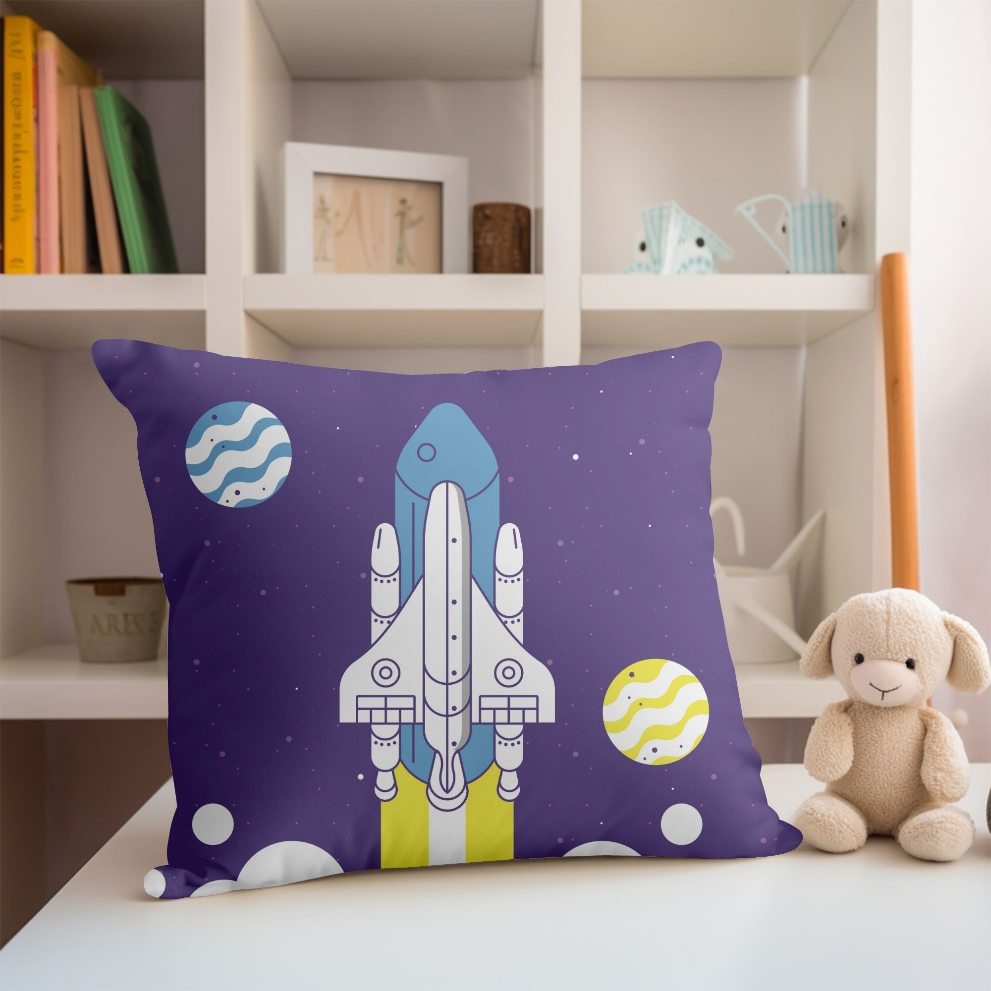 A colorful kids pillow featuring a vibrant space rocket design, perfect for children's rooms and outdoor use.