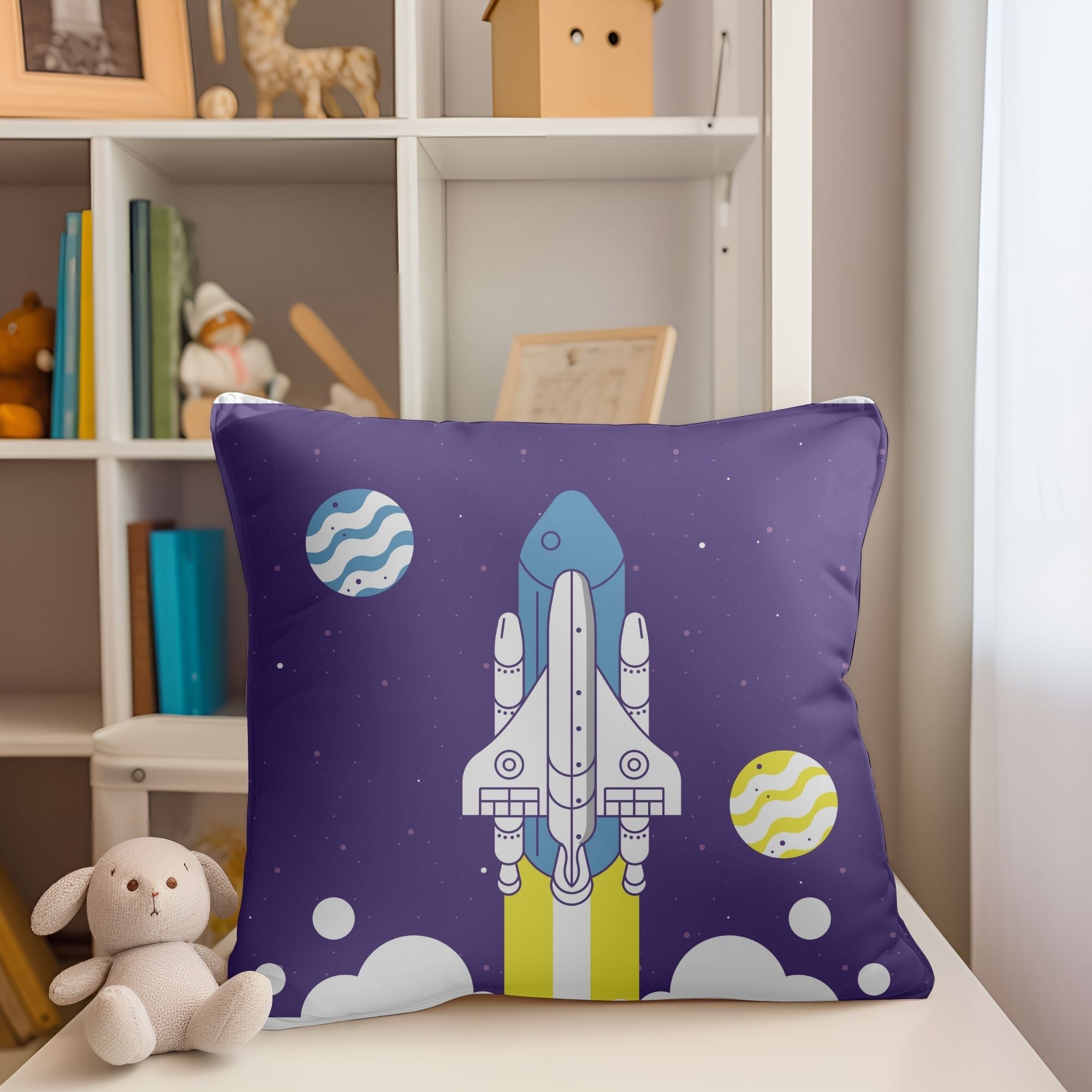 A colorful kids pillow featuring a vibrant space rocket design, perfect for children's rooms and outdoor use.