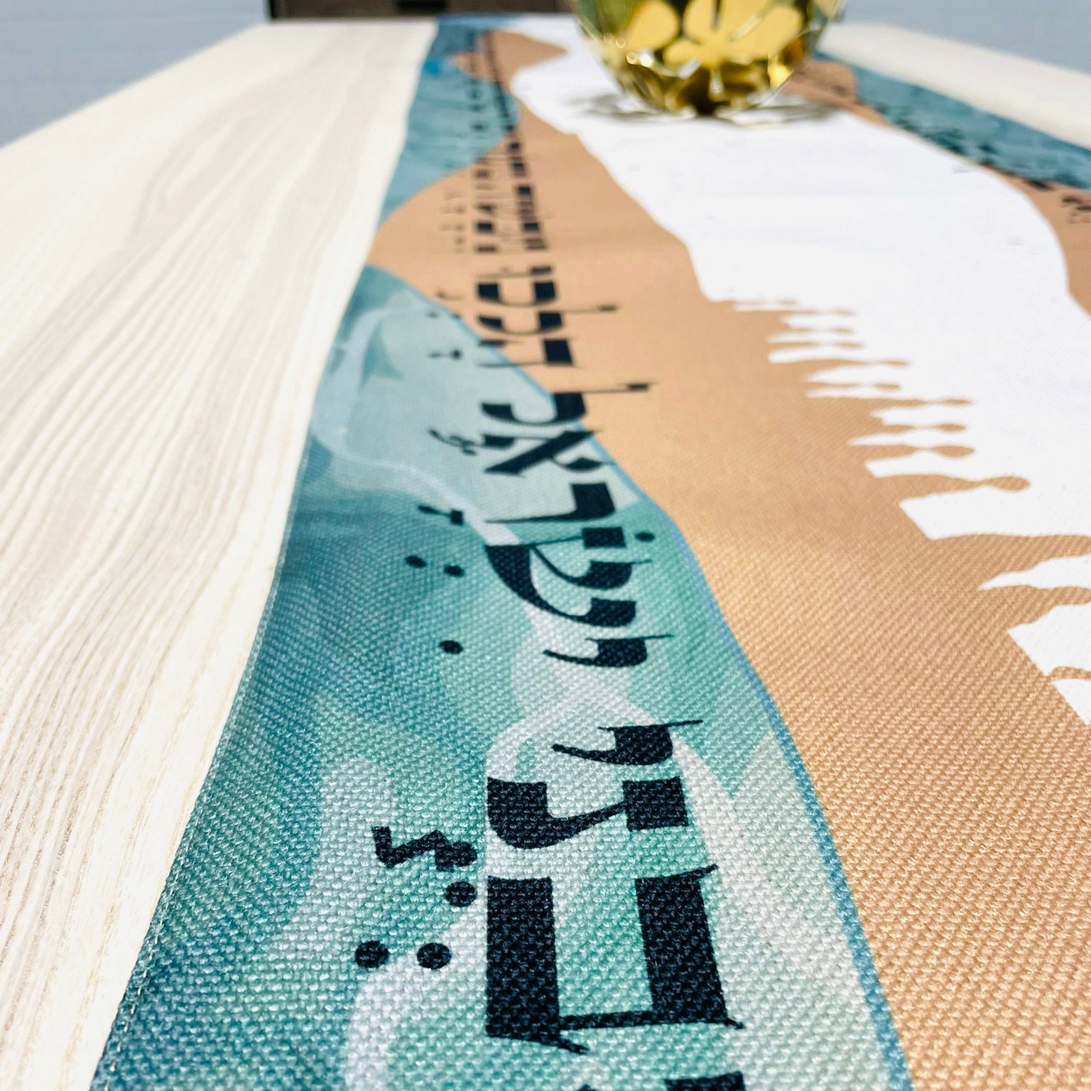 Elegant Split the Sea Passover Table Runner featuring Hebrew writing and beautiful icons, made from cotton linen blend and soft satin.