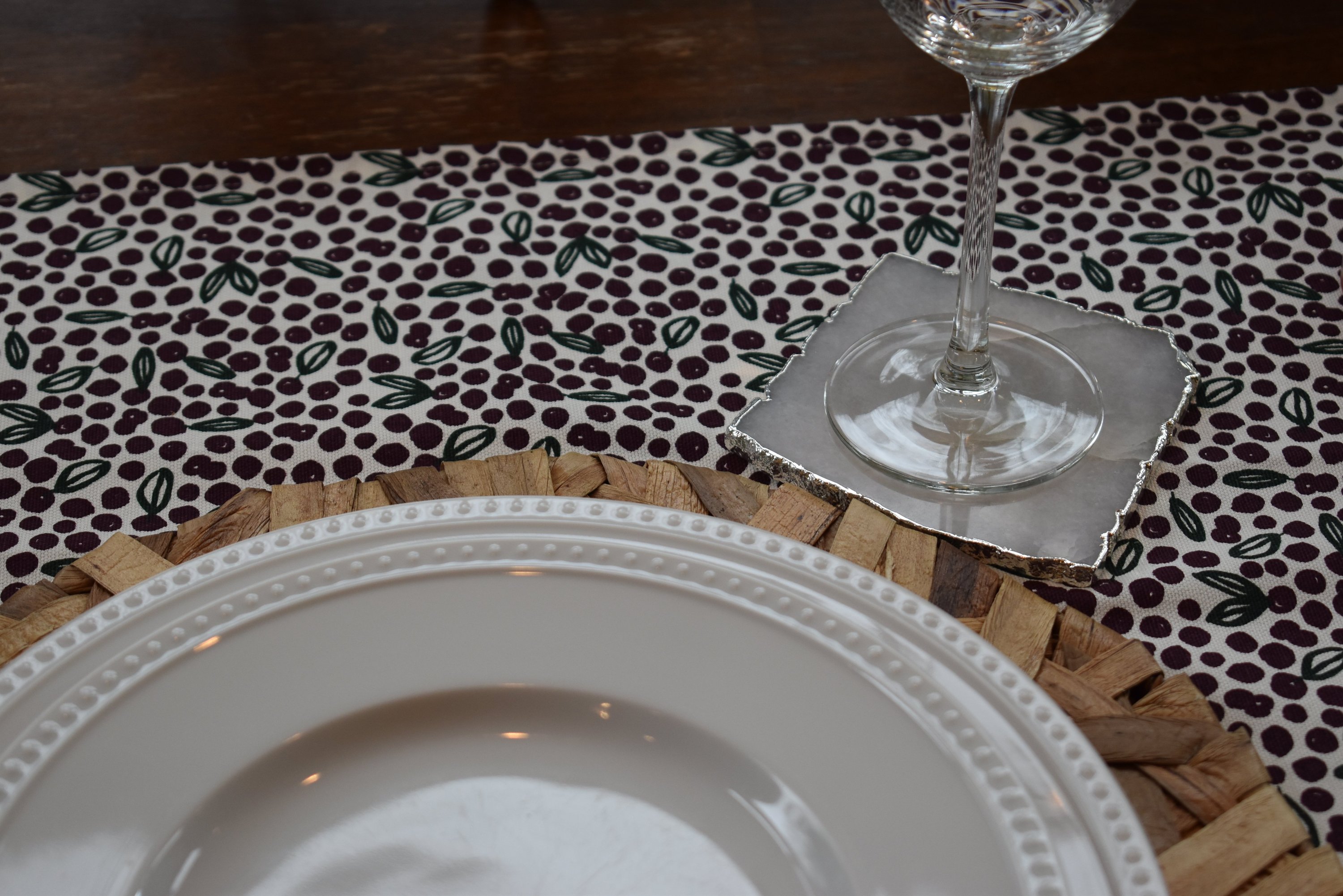 Set of four square coasters with gold trim, featuring amethyst, rose quartz, and clear quartz designs, elegantly protecting tabletops.