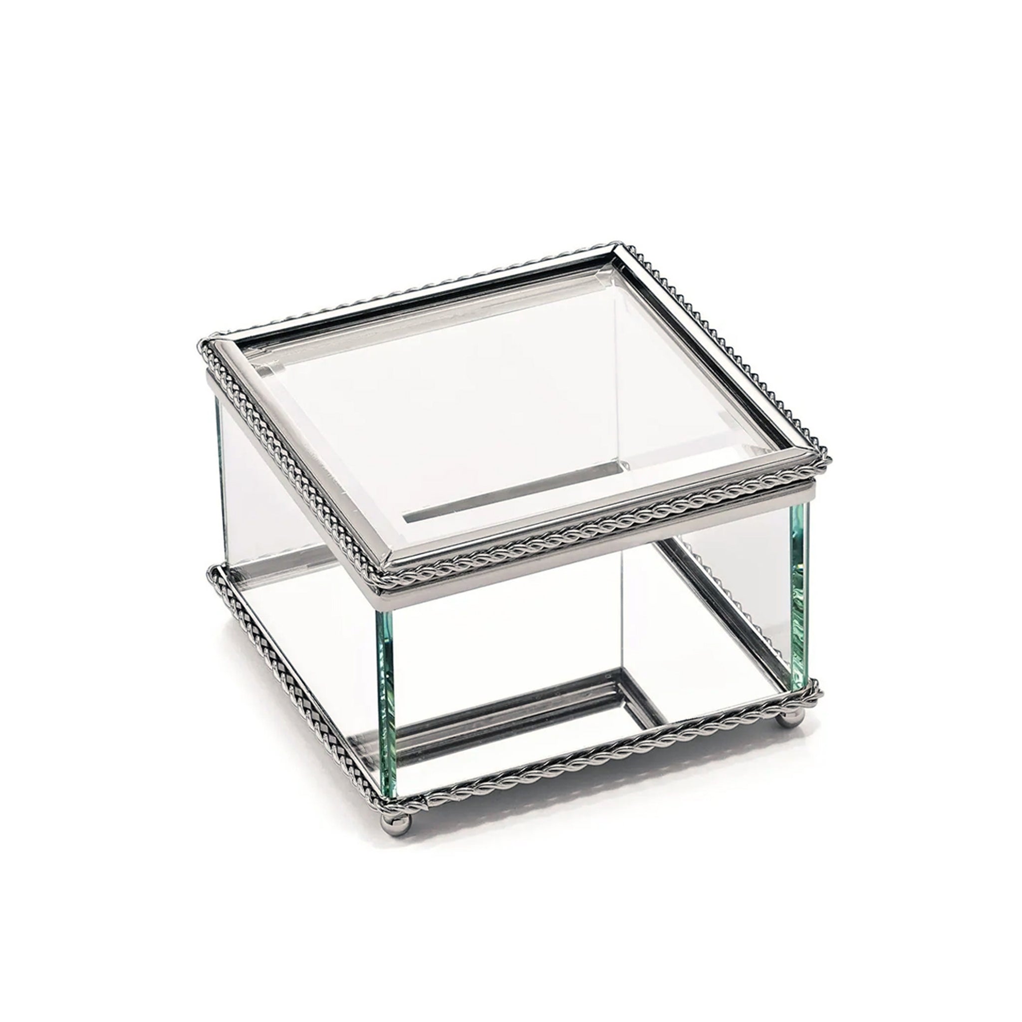 A 3.75-inch square glass box with a hinged cover, featuring a non-tarnish braided border and a mirror bottom, resting on four ball feet.