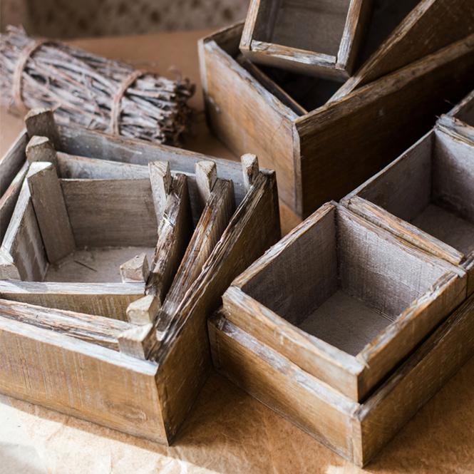 Set of three square solid wood boxes in natural brown color, showcasing different sizes for versatile storage solutions.