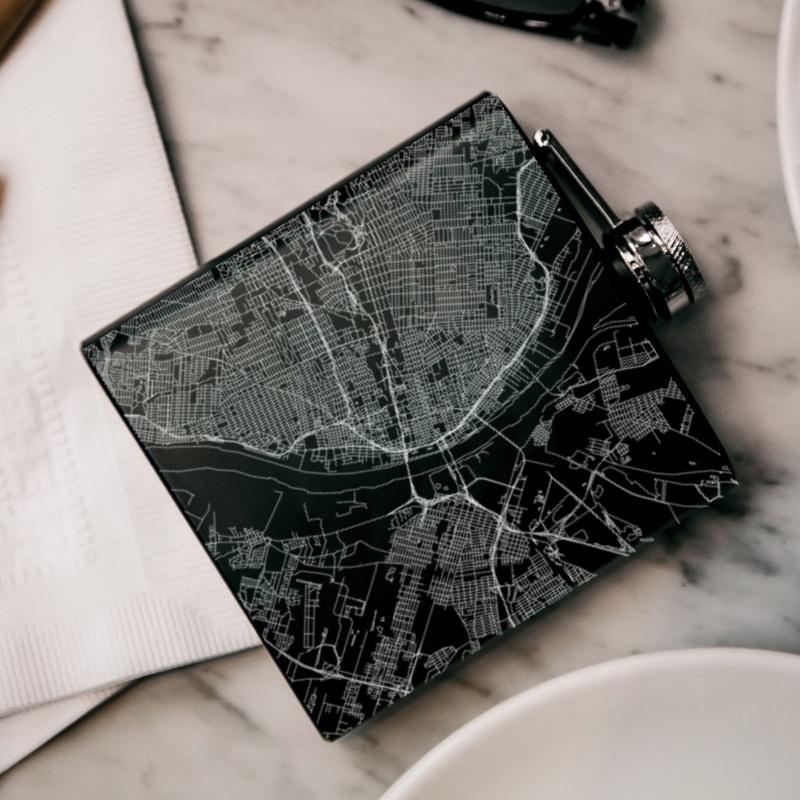 Custom engraved matte black hip flask featuring a detailed map of St. Louis, Missouri with coordinates.