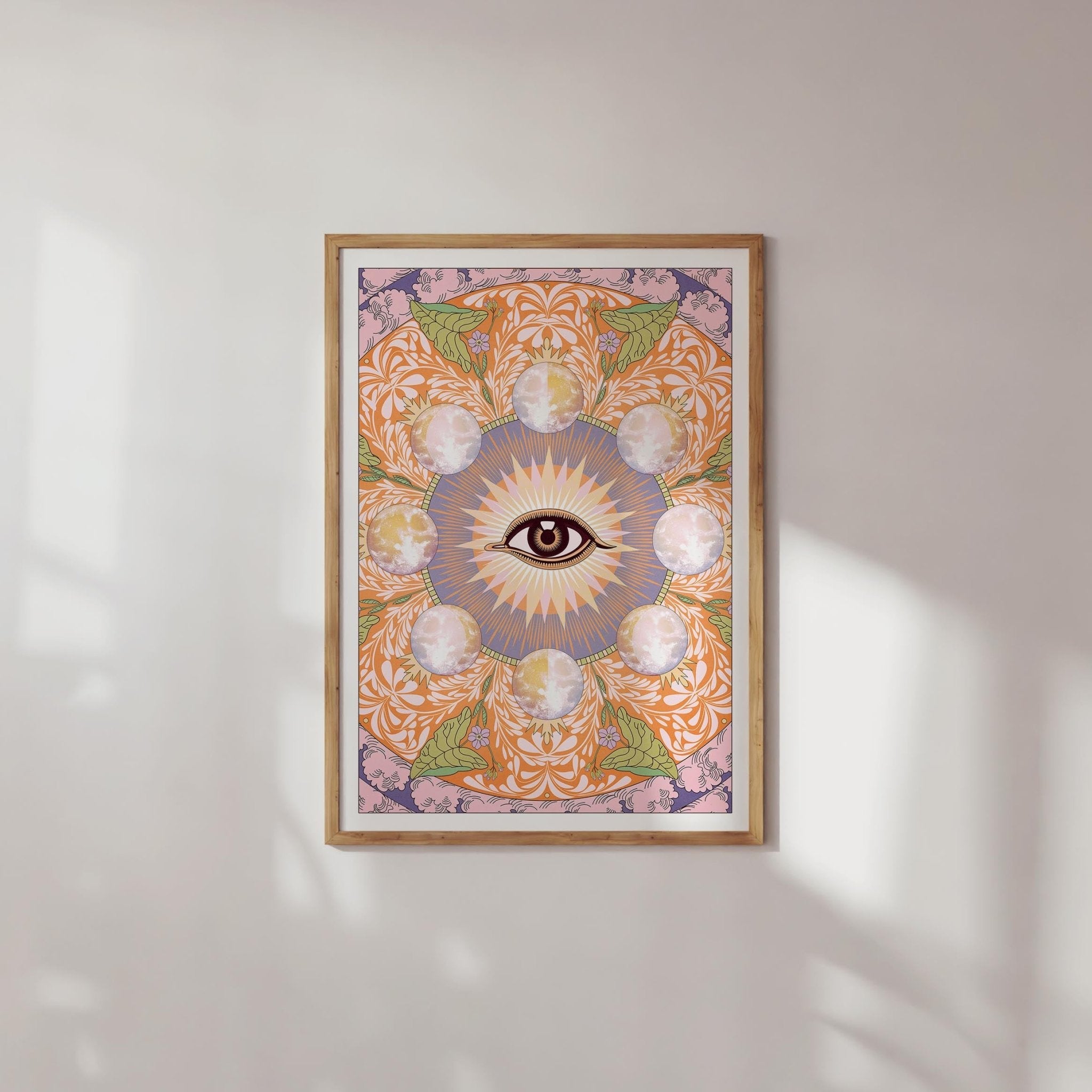 Starry Eyed Art Print featuring an all-seeing eye design surrounded by moons and floral patterns, printed on high-quality paper.