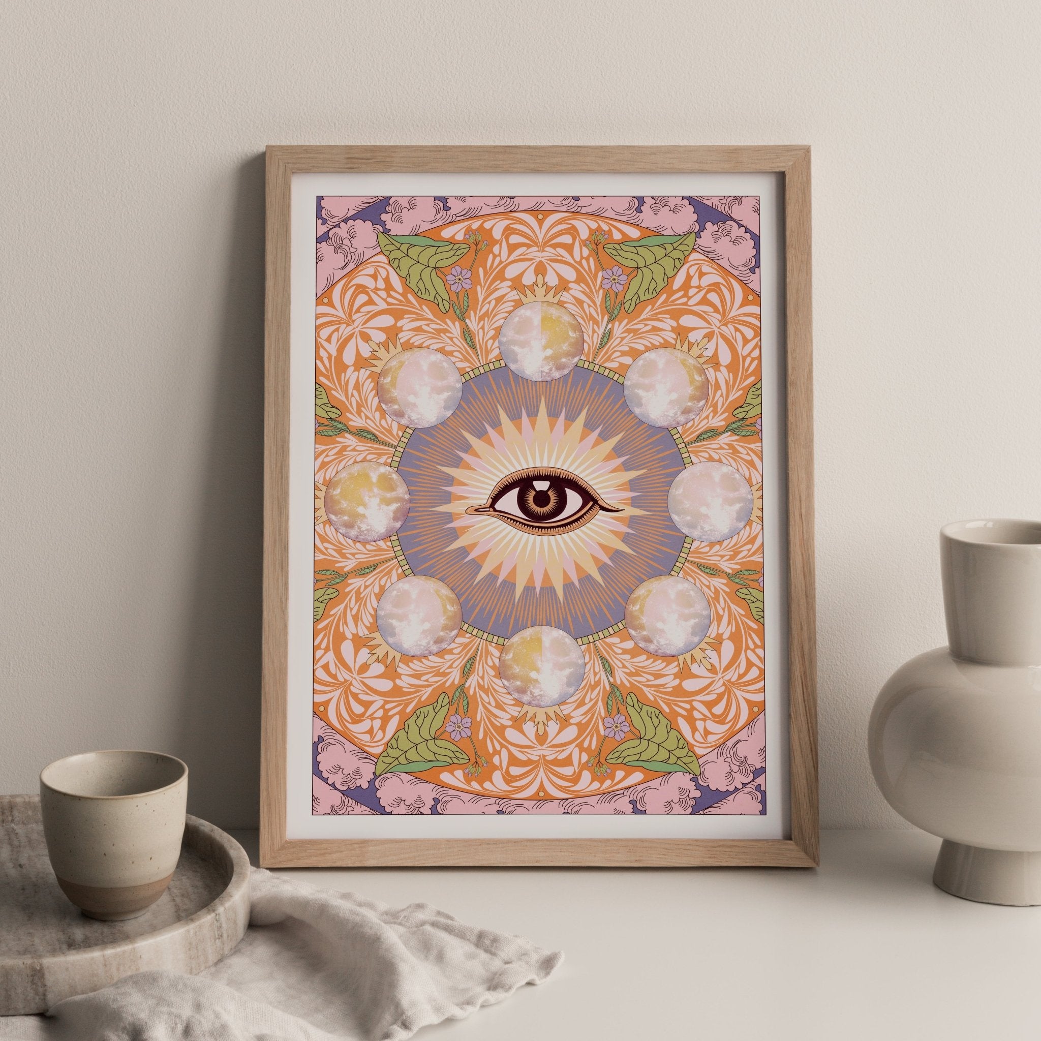 Starry Eyed Art Print featuring an all-seeing eye design surrounded by moons and floral patterns, printed on high-quality paper.