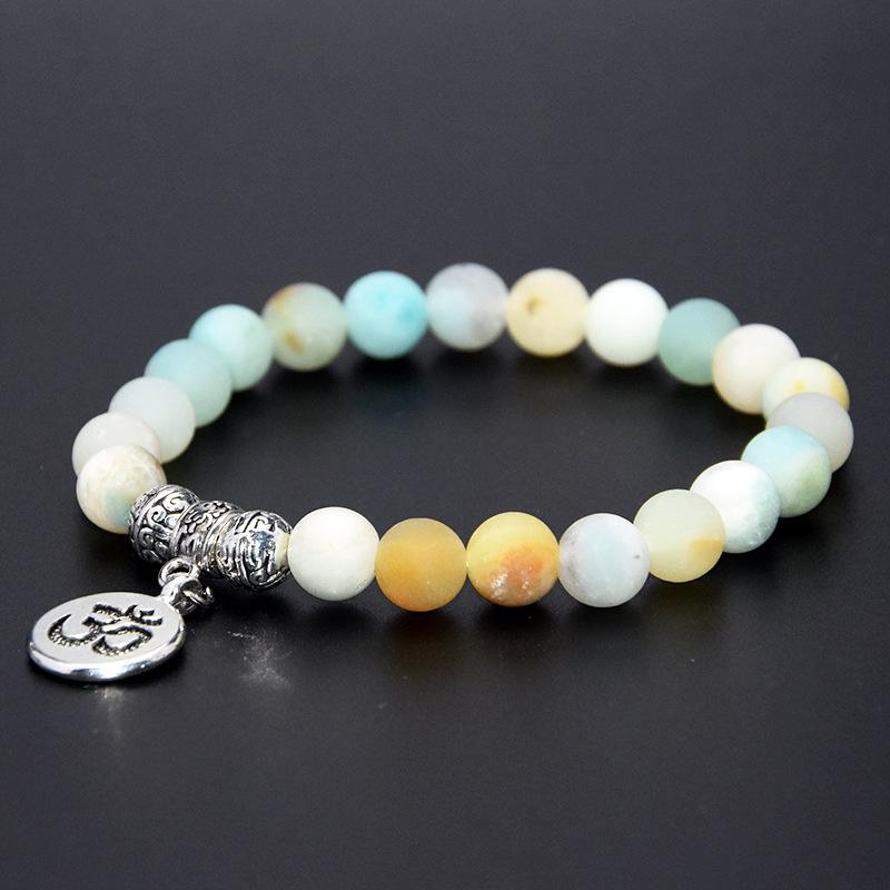 Stone beaded bracelet featuring a Buddha pendant, showcasing elegant design and craftsmanship suitable for both men and women.