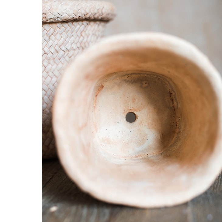 Straw Basket Style Concrete Planter in khaki color, showcasing its elegant design and drainage hole.