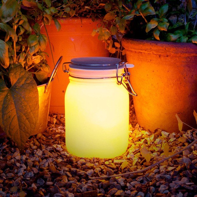 Glowing jar in a garden.