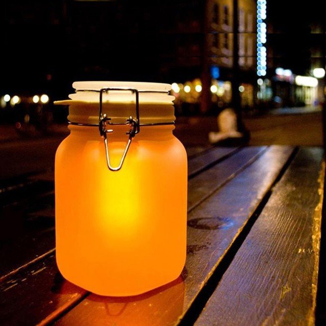 Glowing jar on wooden table.