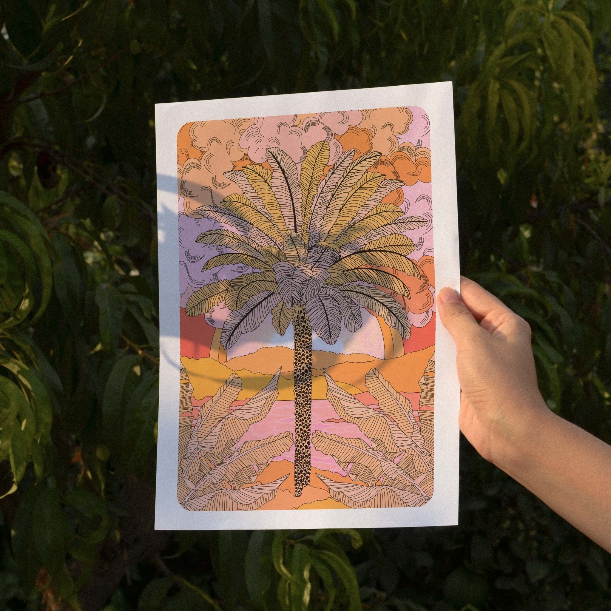 Sunset Palm Art Print featuring a palm tree illustration with mountains and a warm orange sunset gradient.