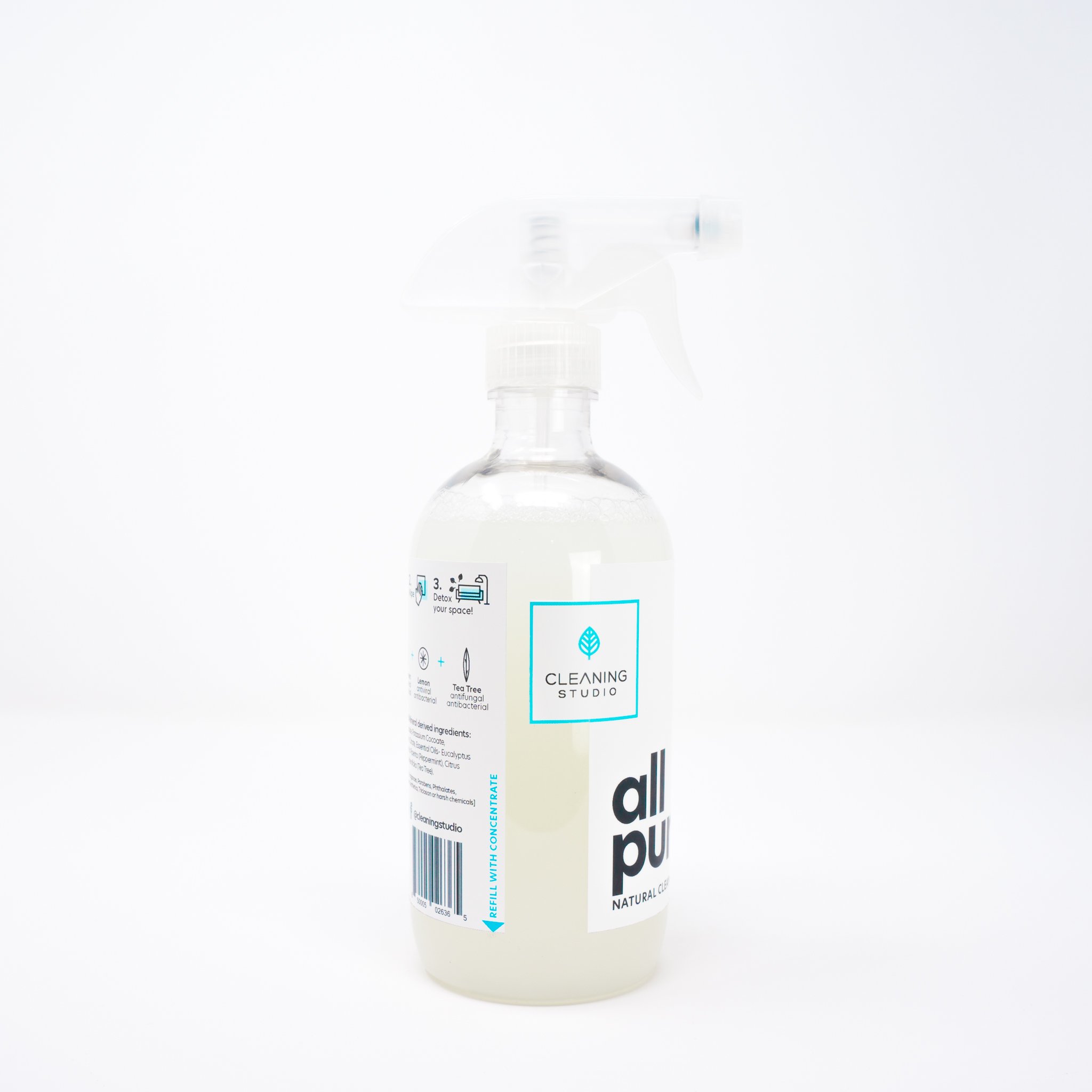 Eco-friendly surface cleaner in a plastic bottle with a spray nozzle, showcasing its natural ingredients and 2oz concentrate.