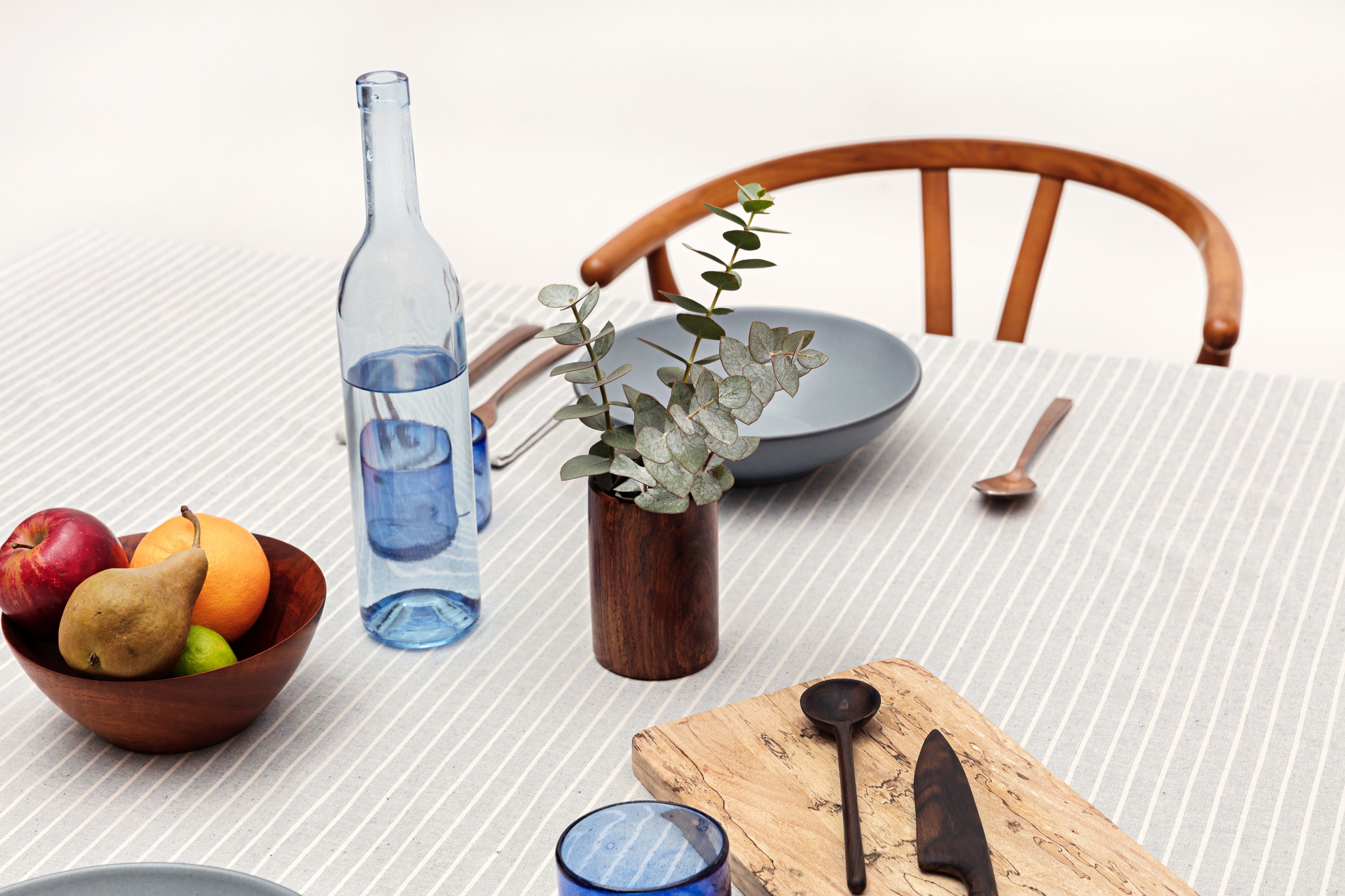 Elegant cotton tablecloth with classic pinstripes in blue-gray and beige colors, perfect for dining occasions.