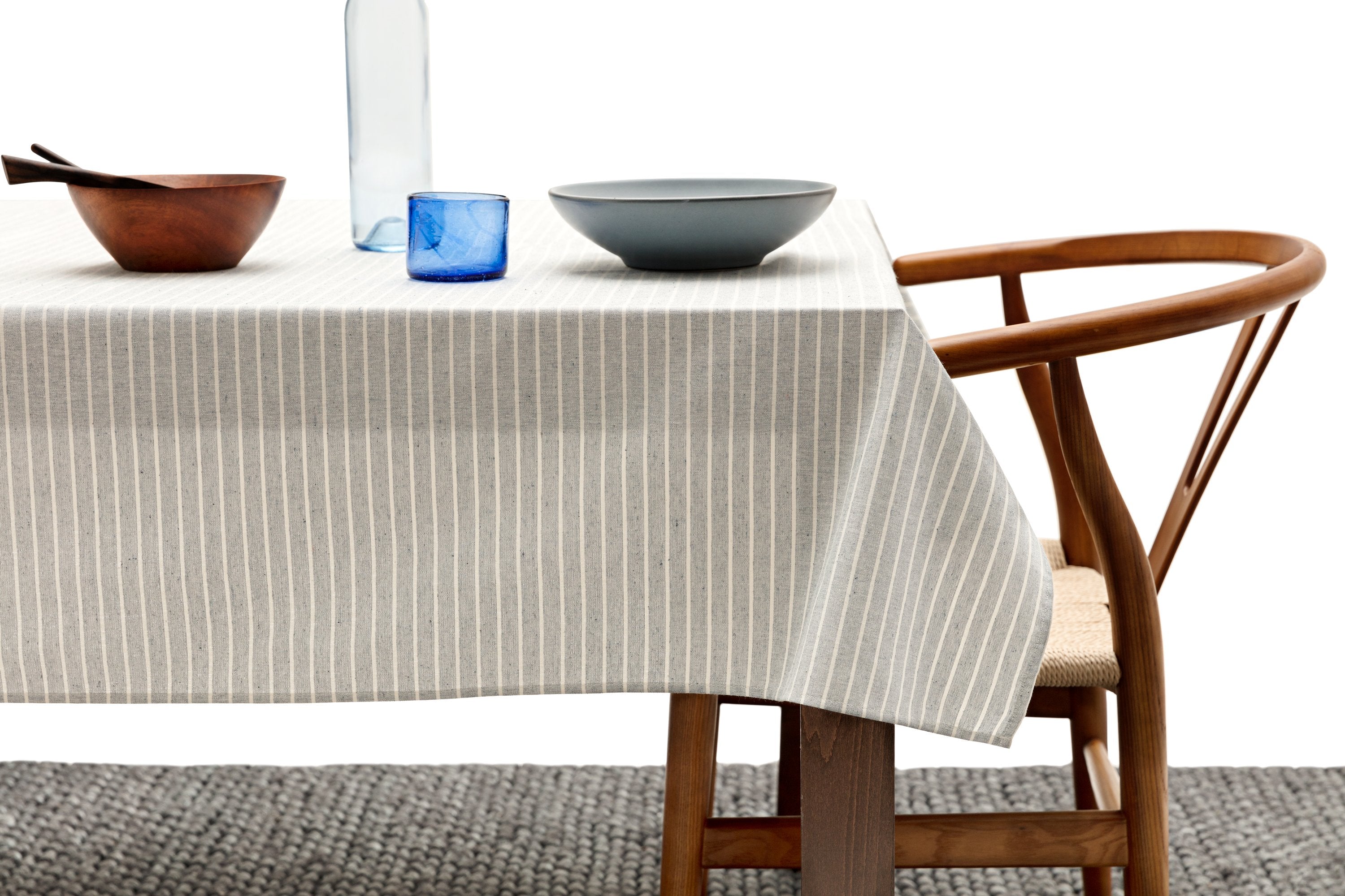 Elegant cotton tablecloth with classic pinstripes in blue-gray and beige colors, perfect for dining occasions.