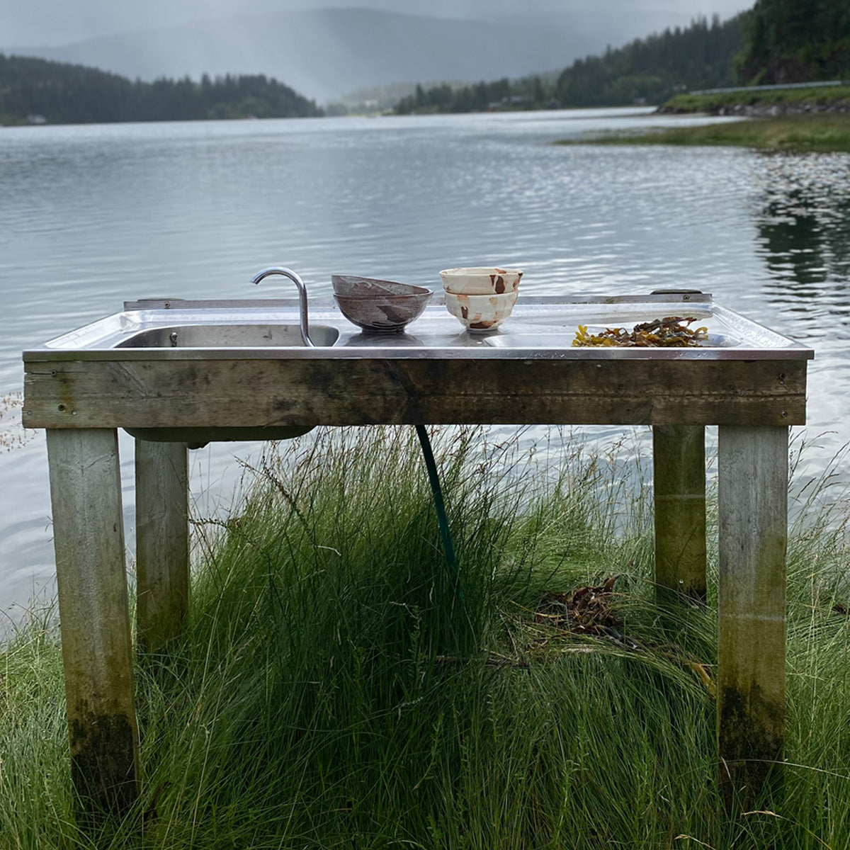 A large TANG ceramic bowl with a unique glaze made from local seaweeds, showcasing its handmade craftsmanship and imperfect design.