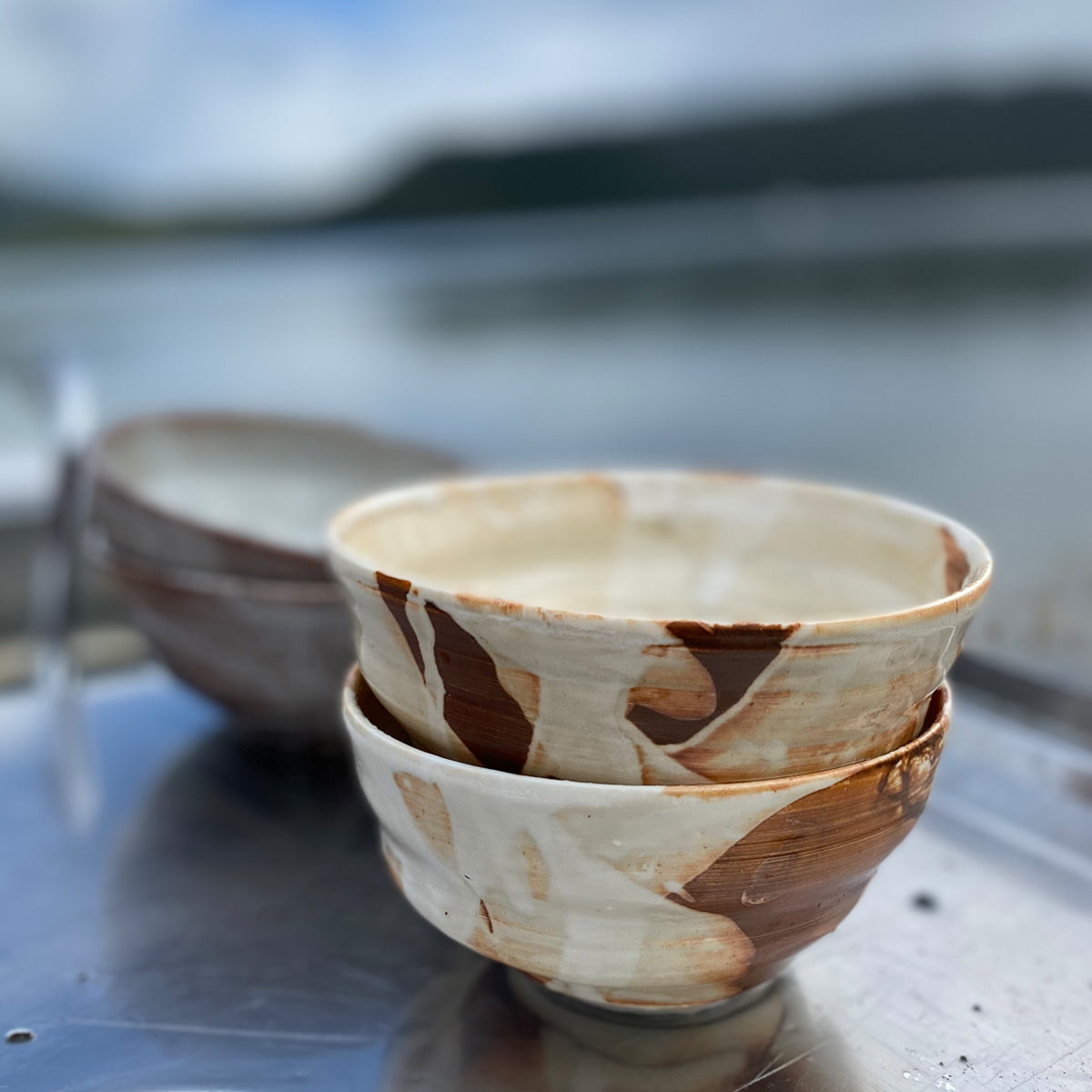 A medium-sized TANG ceramic bowl, handmade in Lofoten, featuring a unique glaze from local seaweeds, showcasing its imperfectly perfect design.