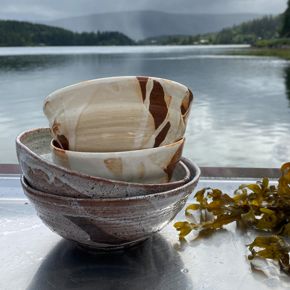 A medium-sized TANG ceramic bowl, handmade in Lofoten, featuring a unique glaze from local seaweeds, showcasing its imperfectly perfect design.