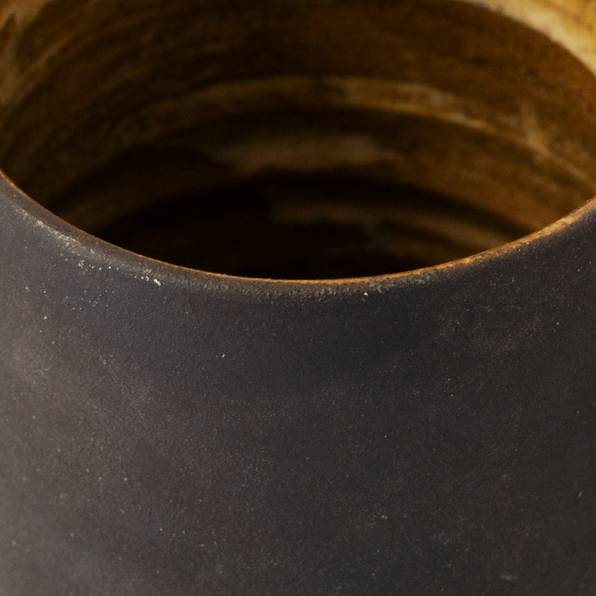 A unique handmade black ceramic mug by Gunvor Tangrand, inspired by Lofoten nature, showcasing artisanal craftsmanship.