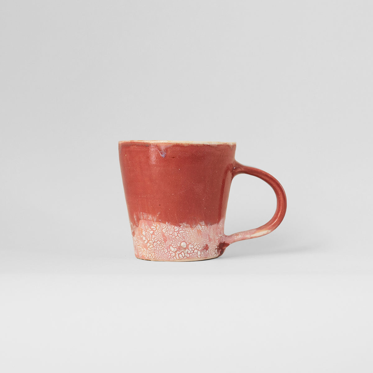 Handmade pink ceramic mug by Gunvor Tangrand, showcasing unique design inspired by Lofoten nature.