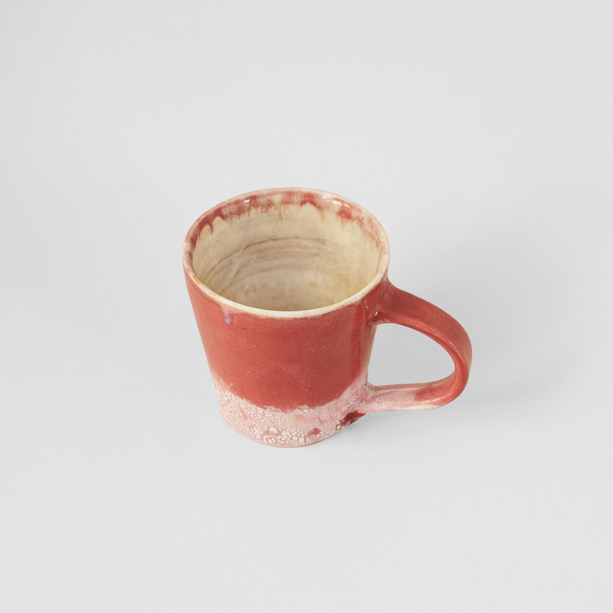 Handmade pink ceramic mug by Gunvor Tangrand, showcasing unique design inspired by Lofoten nature.