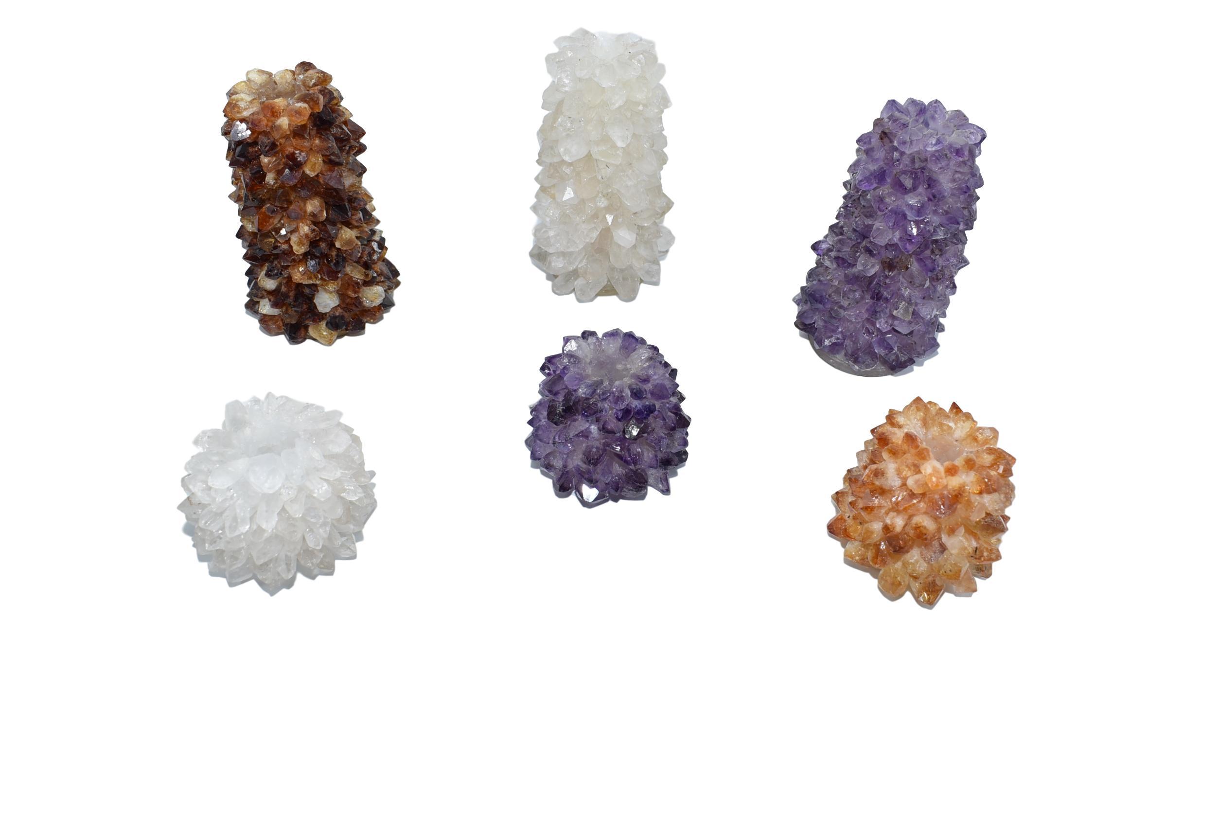 A set of Taper Points Candleholders made from natural citrine, quartz, and amethyst crystals, showcasing their unique shapes and colors.