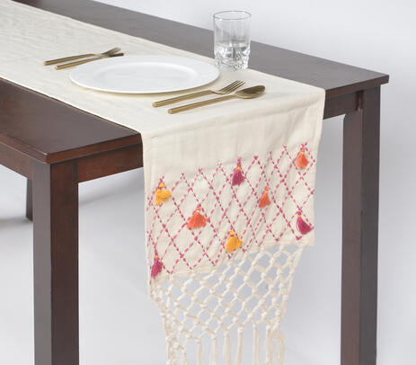 A beautifully crafted tassels and net design table runner made from premium cotton, showcasing intricate patterns and vibrant colors.