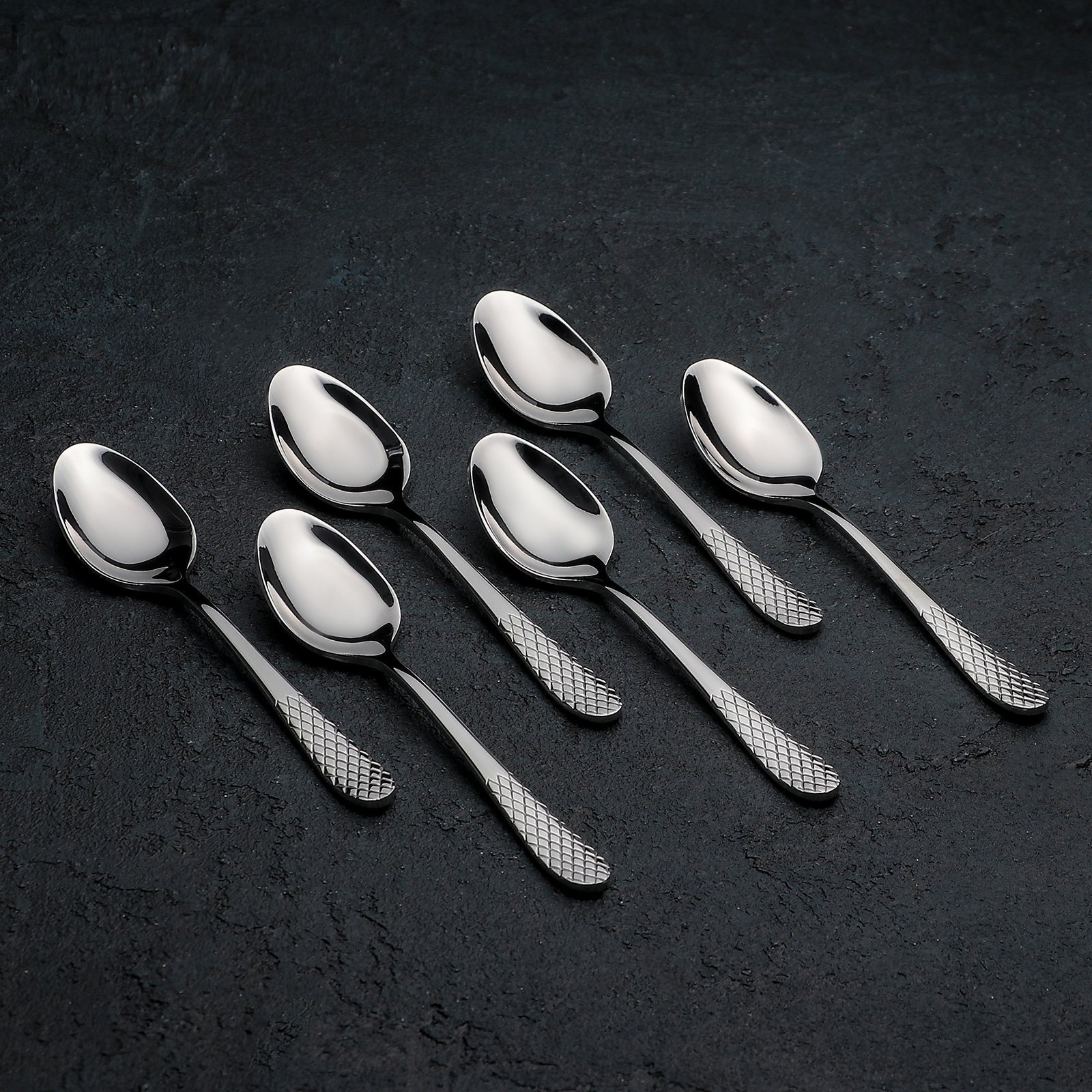 A beautifully arranged set of six 5.5-inch stainless steel teaspoons in an elegant gift box, showcasing their high polish finish.