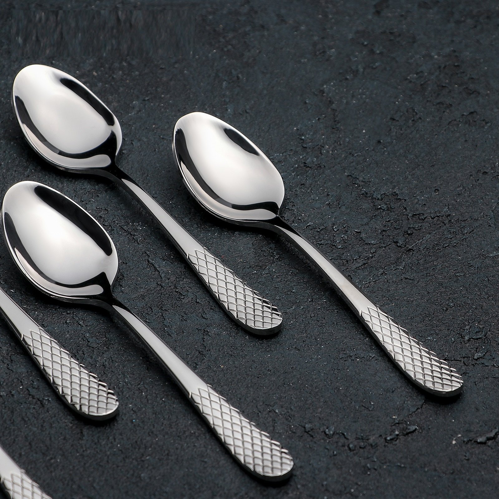 A beautifully arranged set of six 5.5-inch stainless steel teaspoons in an elegant gift box, showcasing their high polish finish.