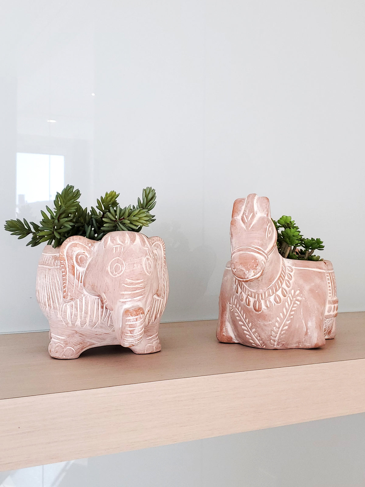 A charming terracotta elephant-shaped pot, perfect for colorful flowers and plants, showcasing its unique design and natural clay finish.