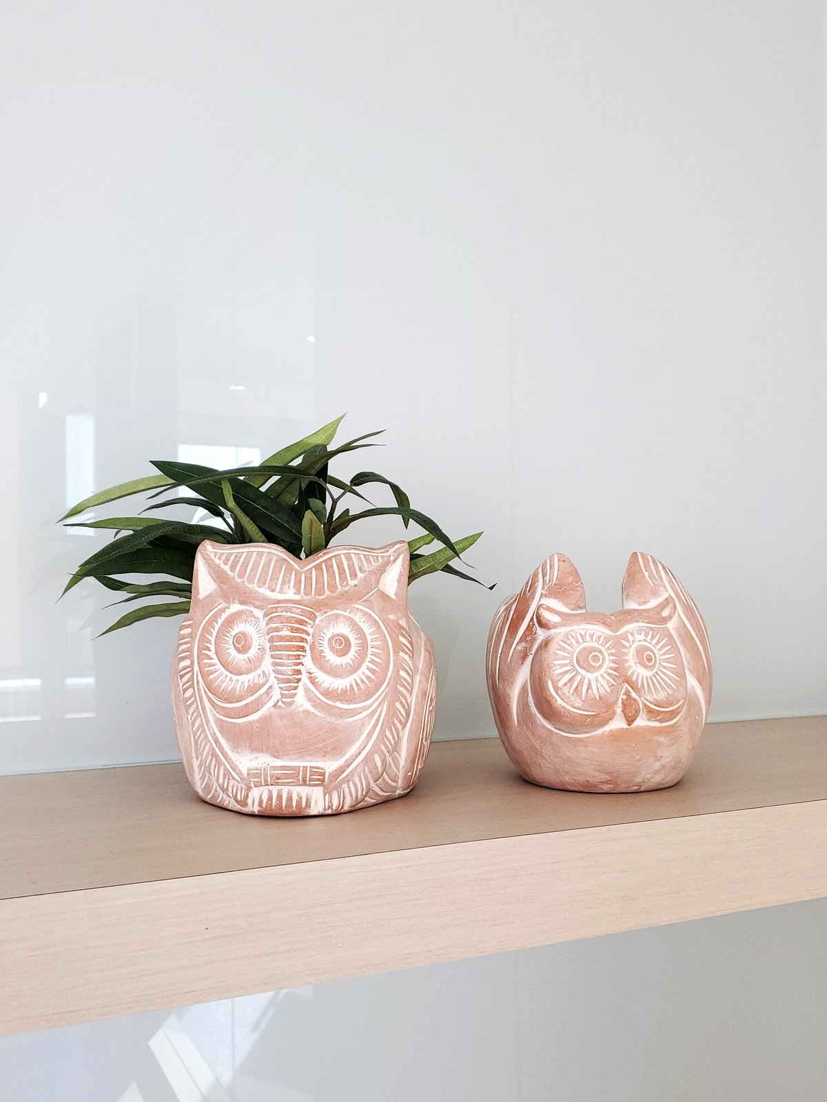 Terracotta pot shaped like a horned owl, perfect for plants and flowers, showcasing unique craftsmanship.